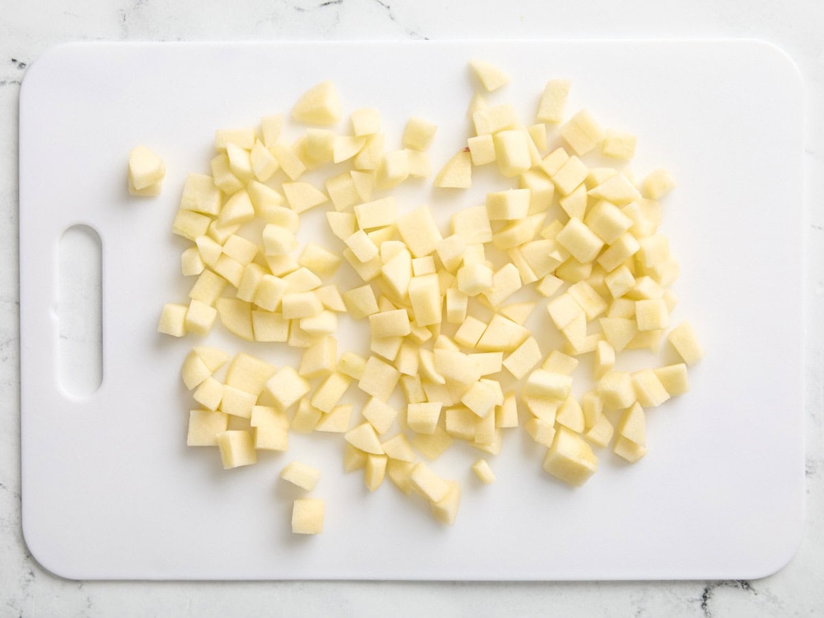 Chopped apples on a cutting board.