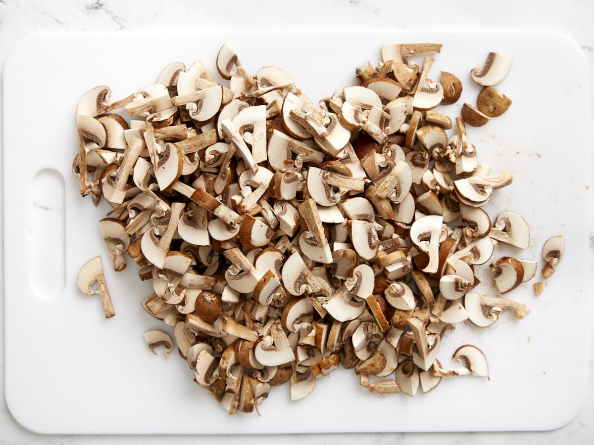 Sliced mushrooms on a cutting board.