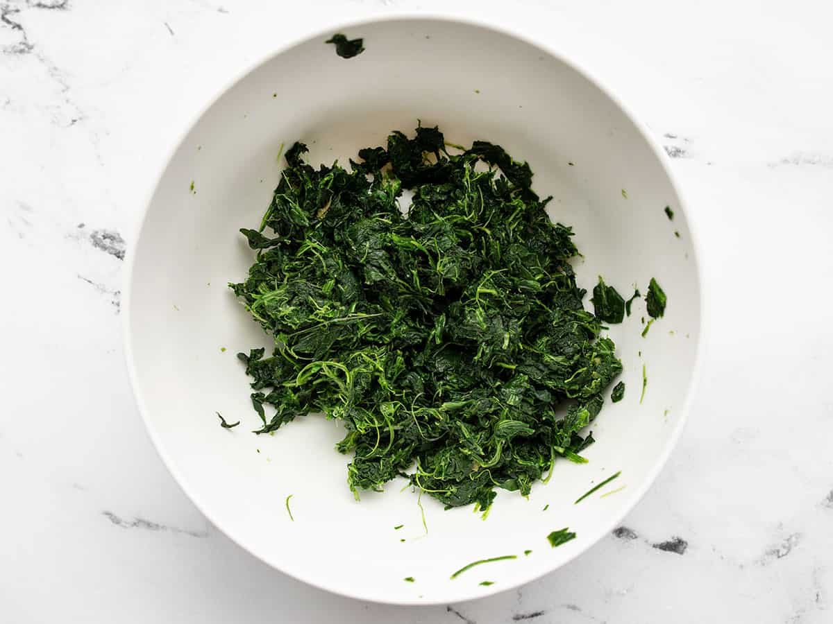 thawed and squeezed spinach in a bowl