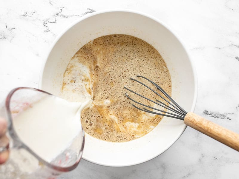 Milk being poured into the mixing bowl