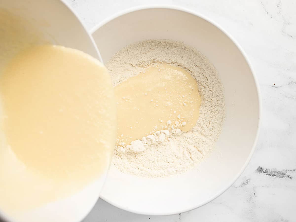 Wet ingredients being poured into dry ingredients.