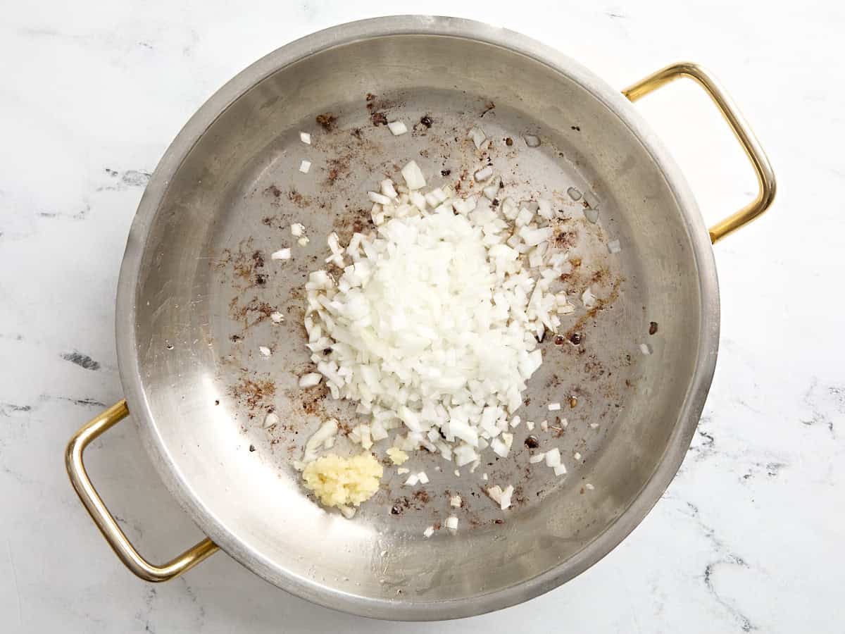 Diced onion and minced garlic added to skillet.