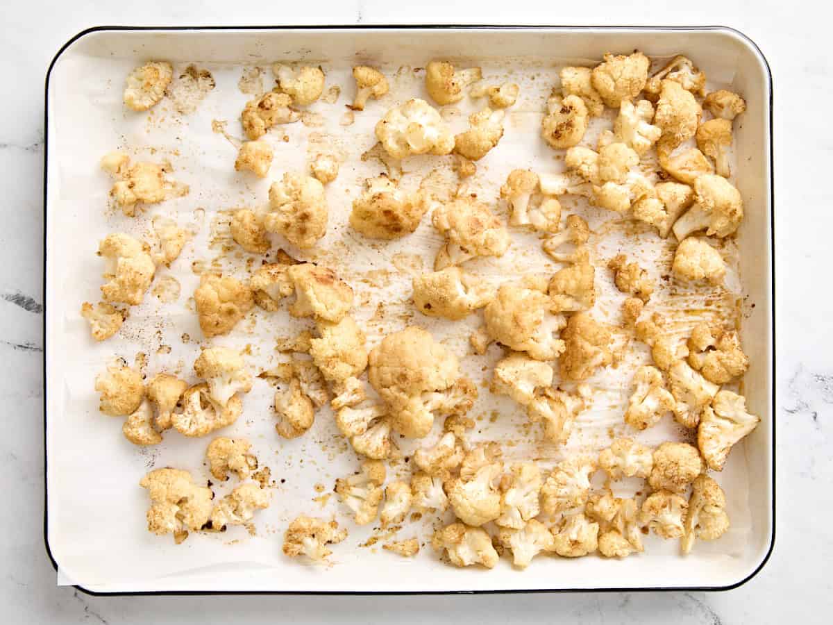 Roasted cauliflower florets on a baking sheet