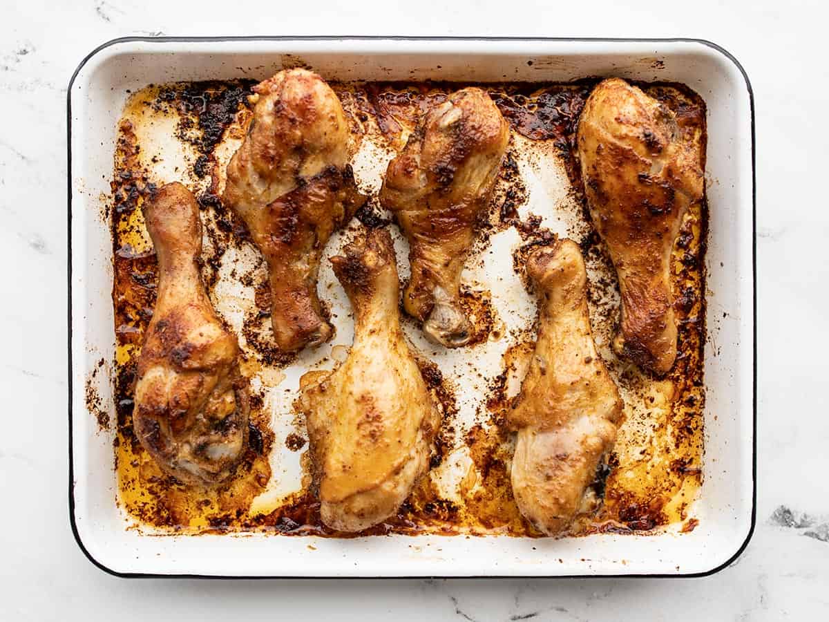 baked drumsticks on a baking sheet