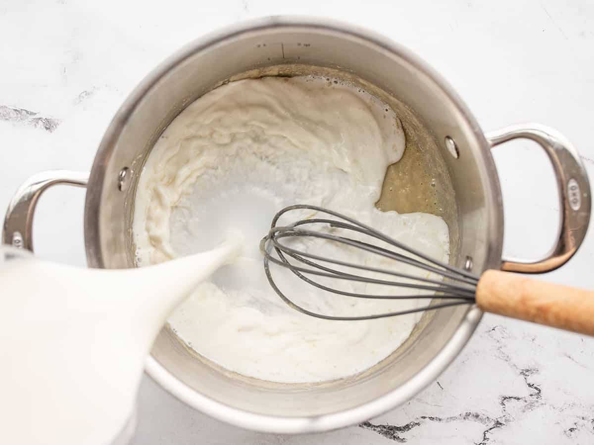 Milk being poured into the pot