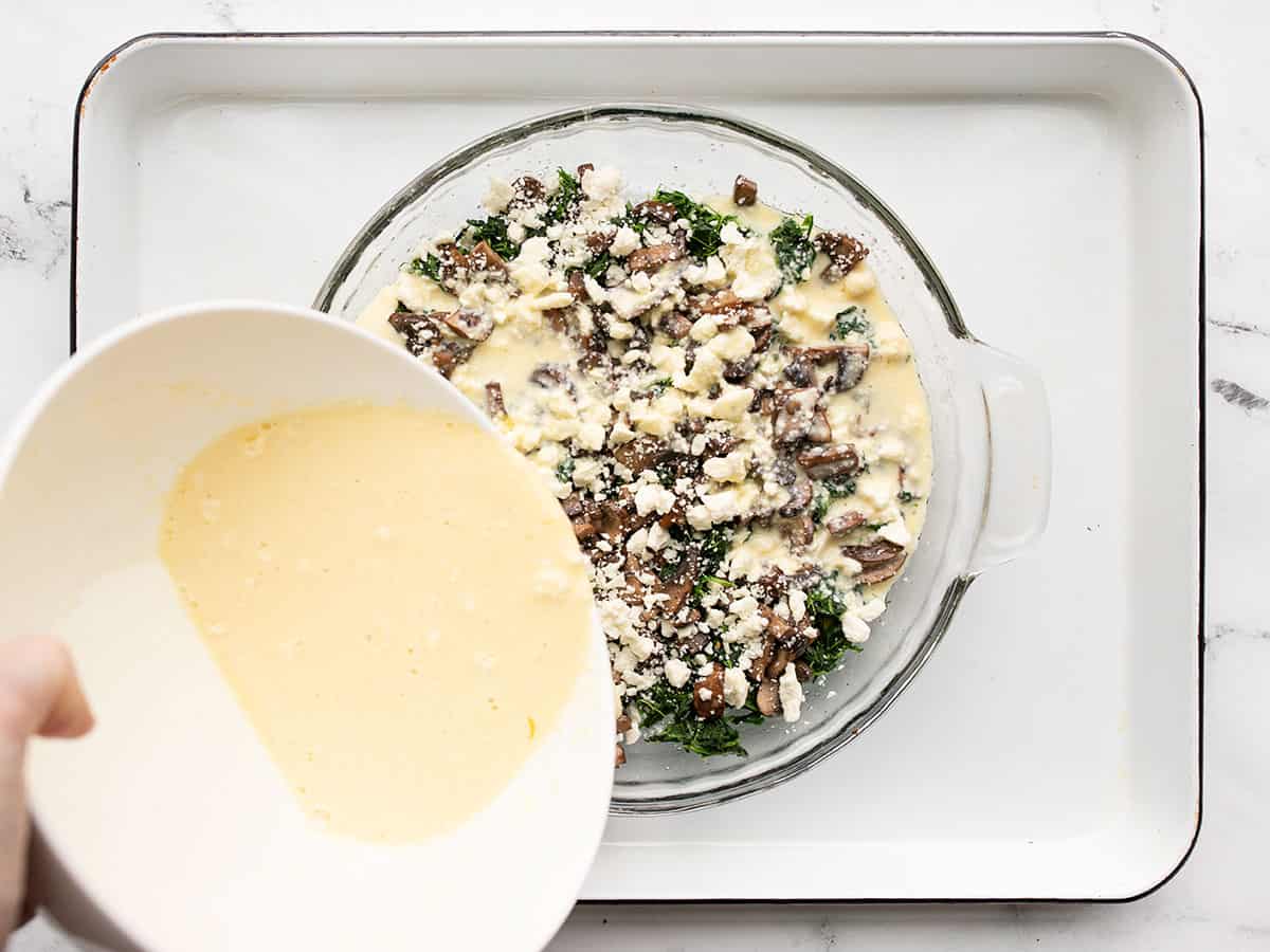 custard mixture being poured into the pie dish