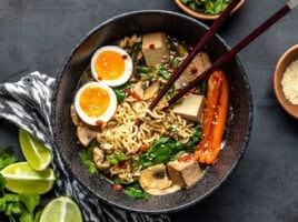 Overhead view of the finished bowl of upgraded instant ramen with chopsticks in the center.