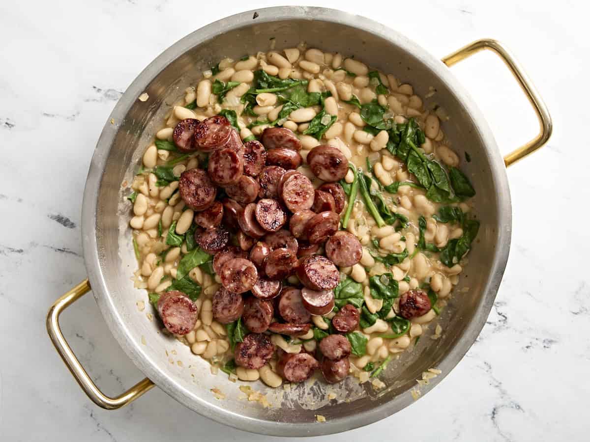 Chicken sausage added back to skillet with white beans and spinach.