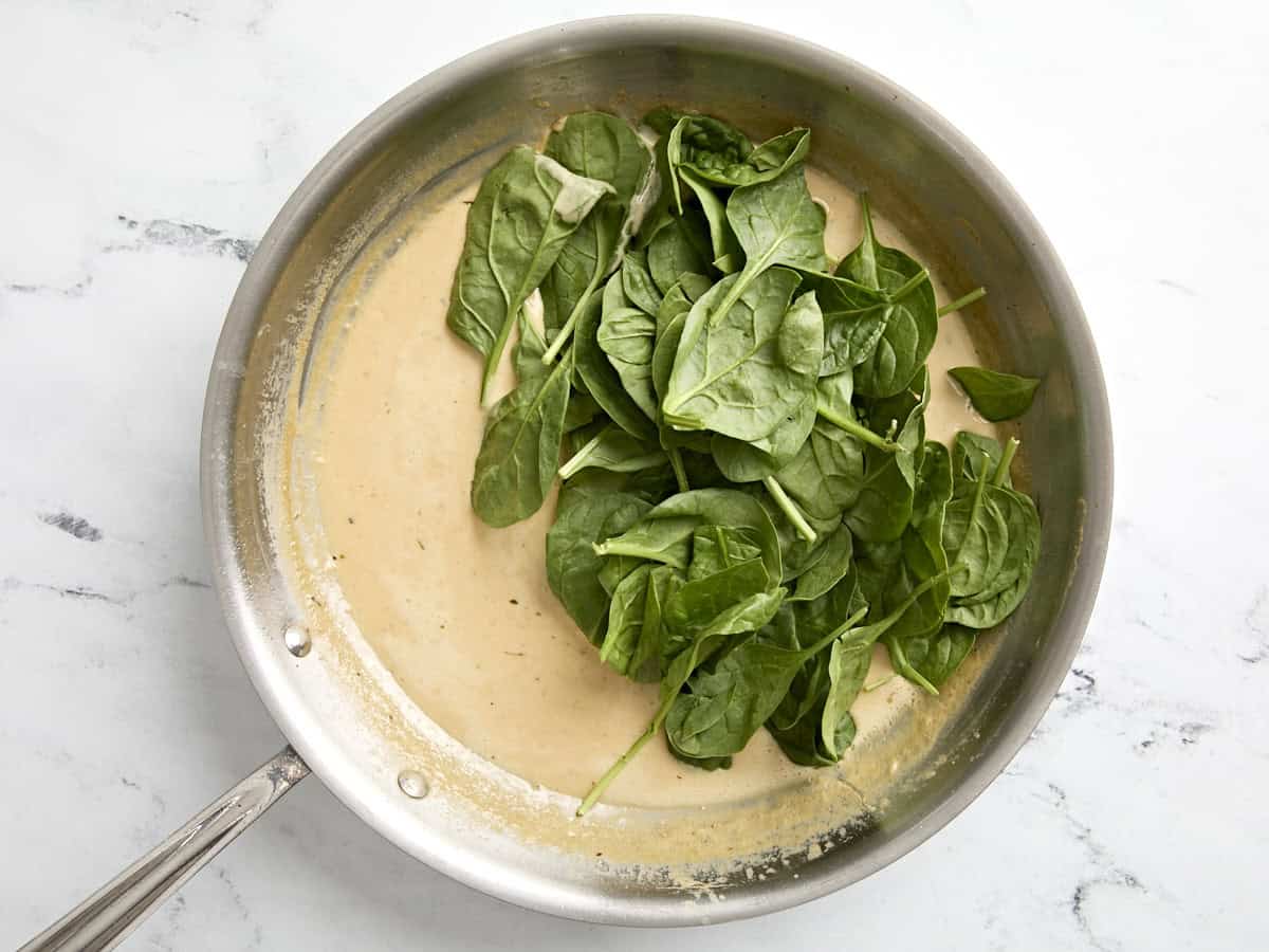 Spinach added to skillet.