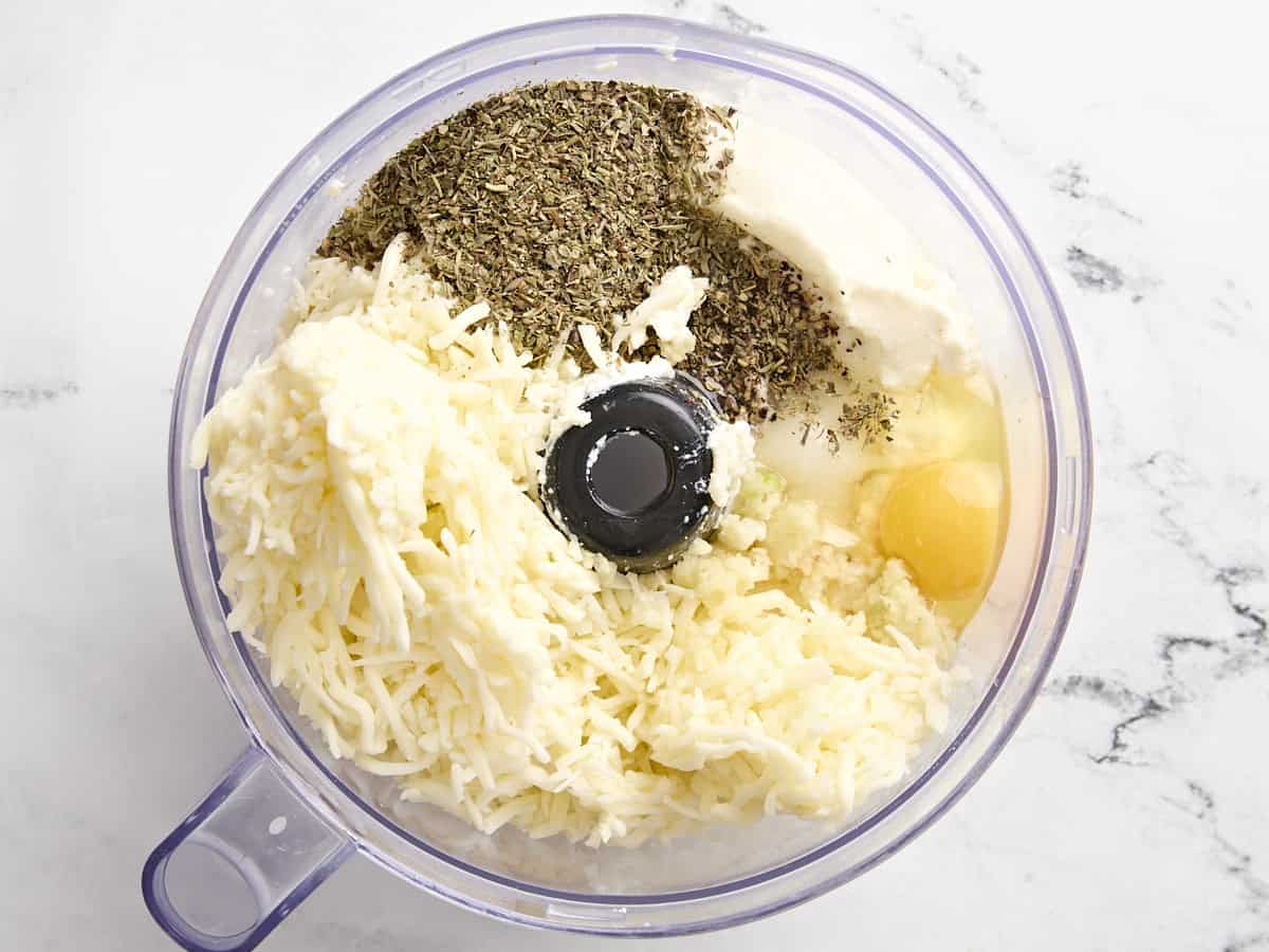 Ingredients for cheese sauce in a food processor