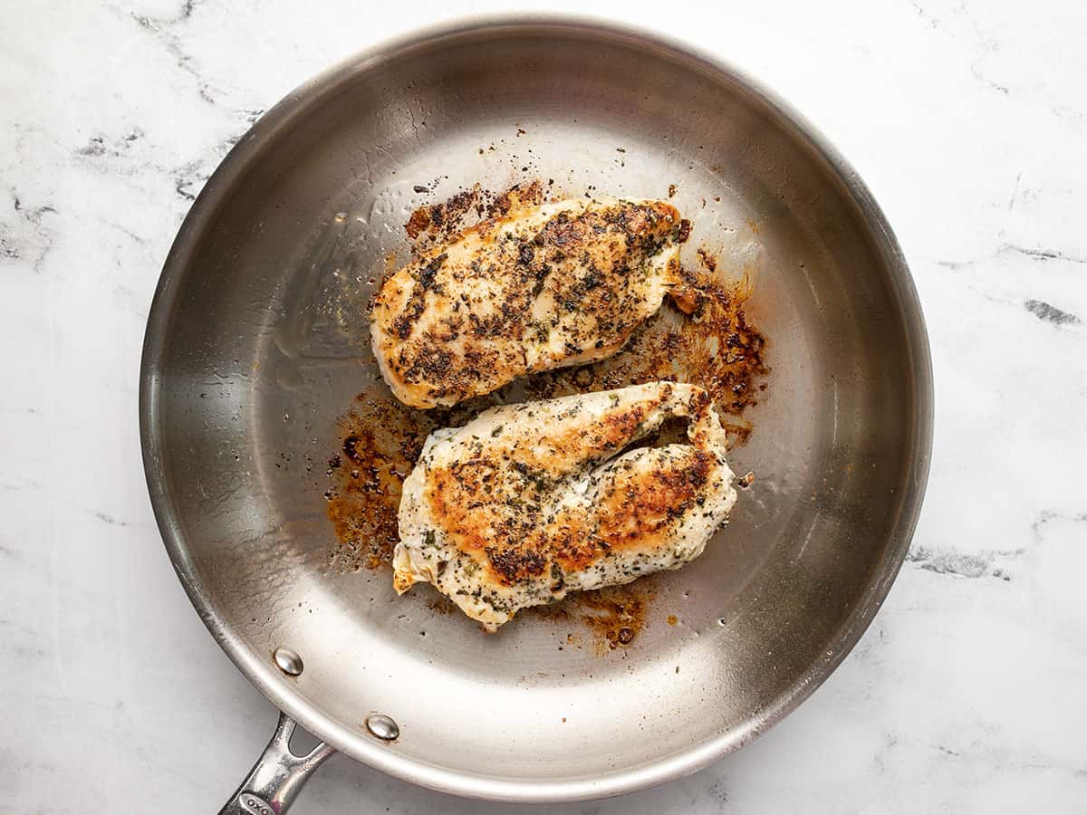 Cooked chicken breast in a skillet.