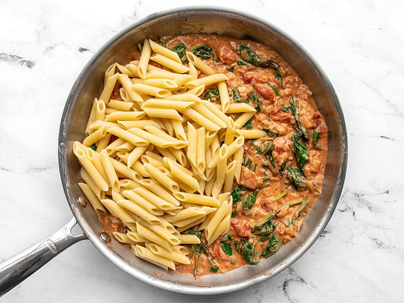 Cooked and drained pasta added to the skillet