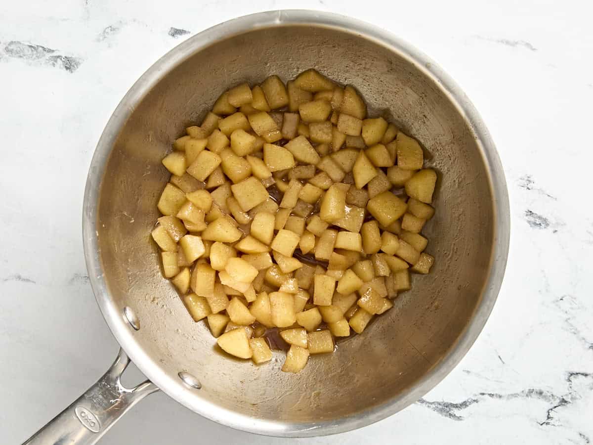 Cooked apples in a small pot.