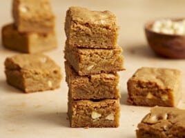 Side close up view of four blondie bars stacked on top of each other.