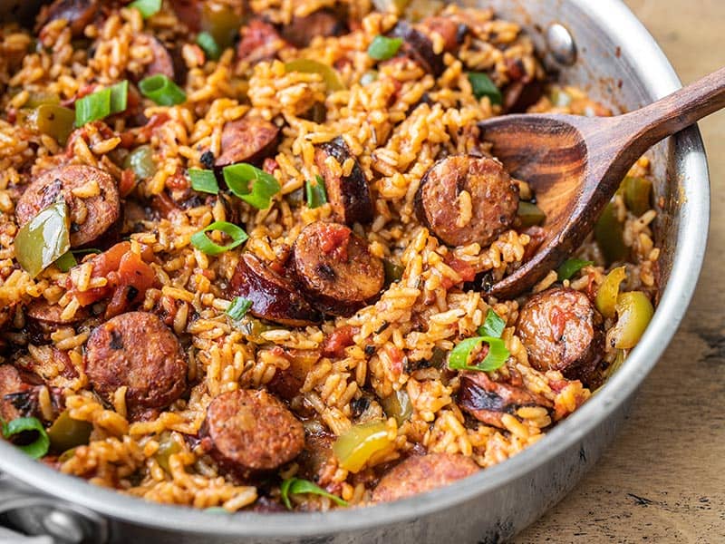 Side view of a skillet full of Cajun Sausage and Rice