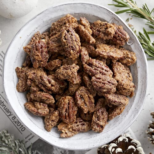 Overhead view of a bowl full of candied pecans.