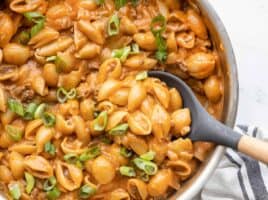 Close up of cheeseburger pasta skillet being scooped out with a spoon