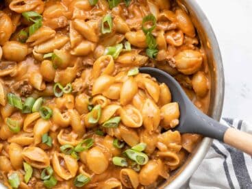 Close up of cheeseburger pasta skillet being scooped out with a spoon