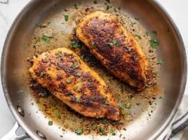 close up of cooked chicken breasts in the skillet