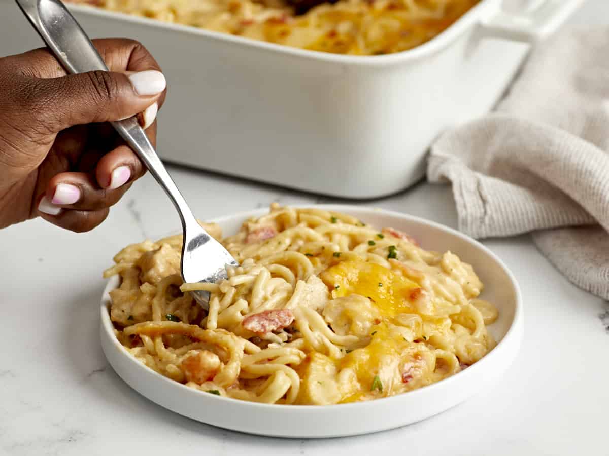 Side view of Chicken Spaghetti plated with a forklifting some out