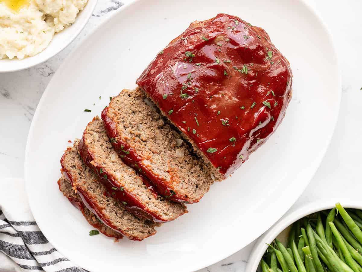 Overhead view of sliced meatloaf on a platter