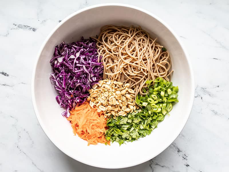 Ingredients for the cold peanut noodle salad in a bowl.