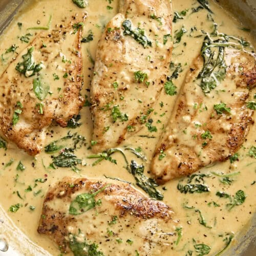 Overhead close up view of creamy dijon chicken in a skillet.