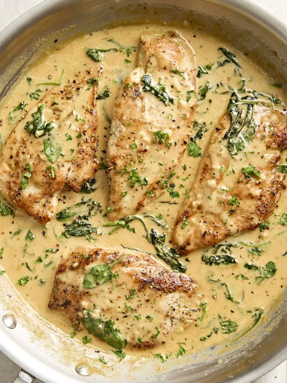 Overhead view of creamy dijon chicken in a skillet.