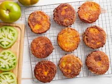 overhead view of fried green tomatoes on a wire rack.