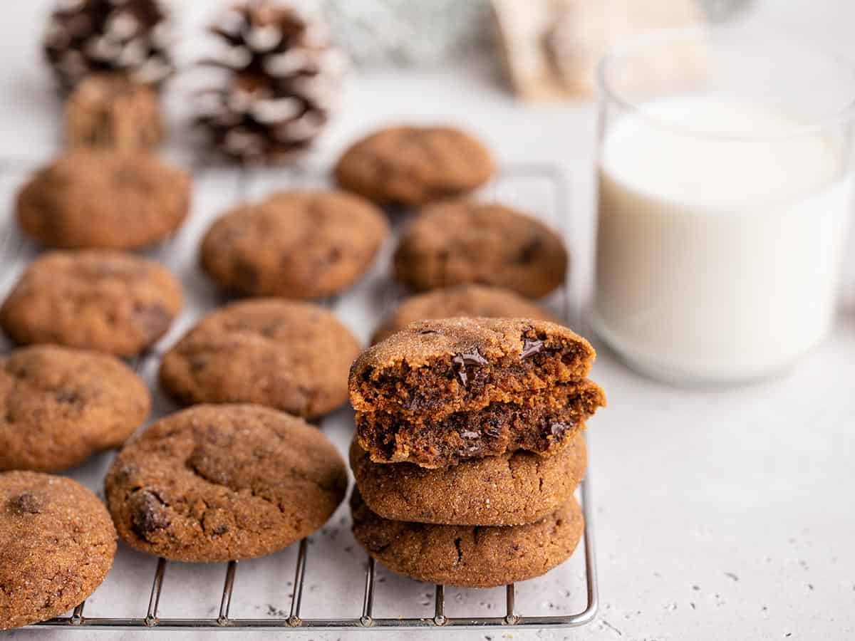 Chocolate molasses cookies stacked on a cooling rack