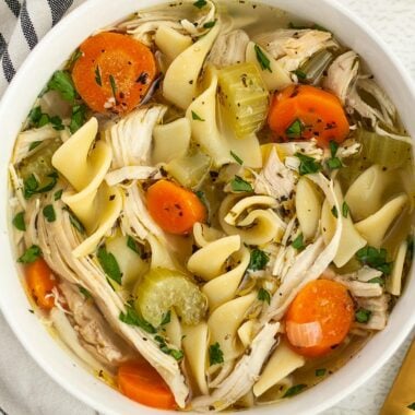 Close up overhead view of a bowl of chicken noodle soup.