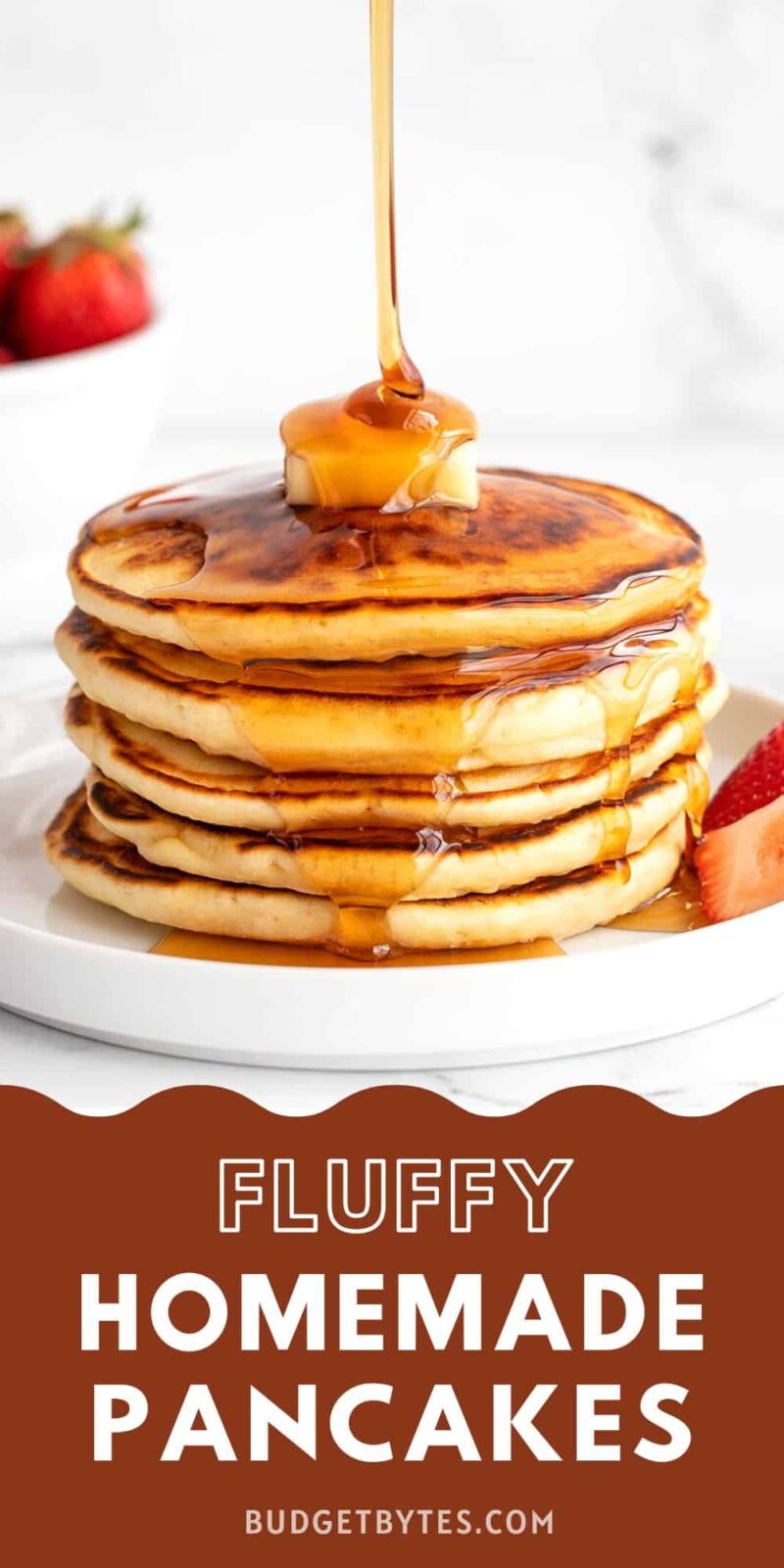 Syrup being poured onto a stack of pancakes.