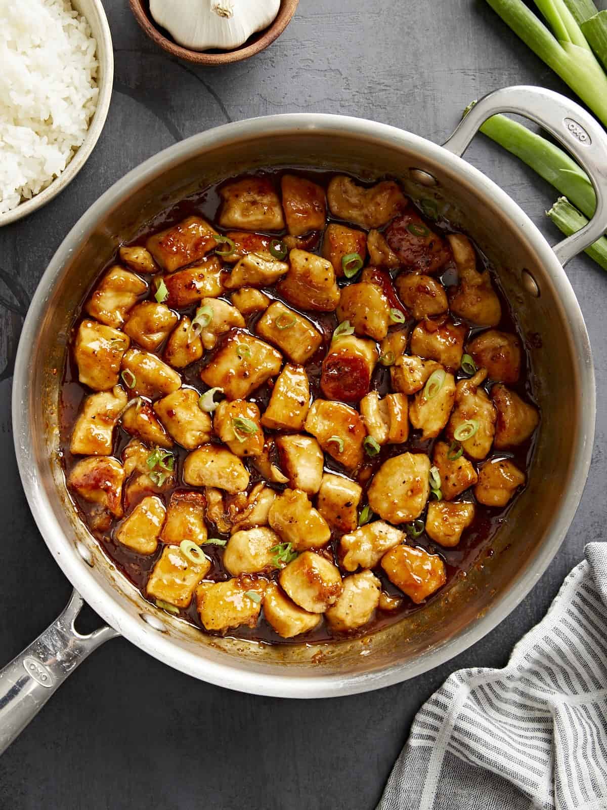 Overhead view of honey garlic chicken in a skillet.