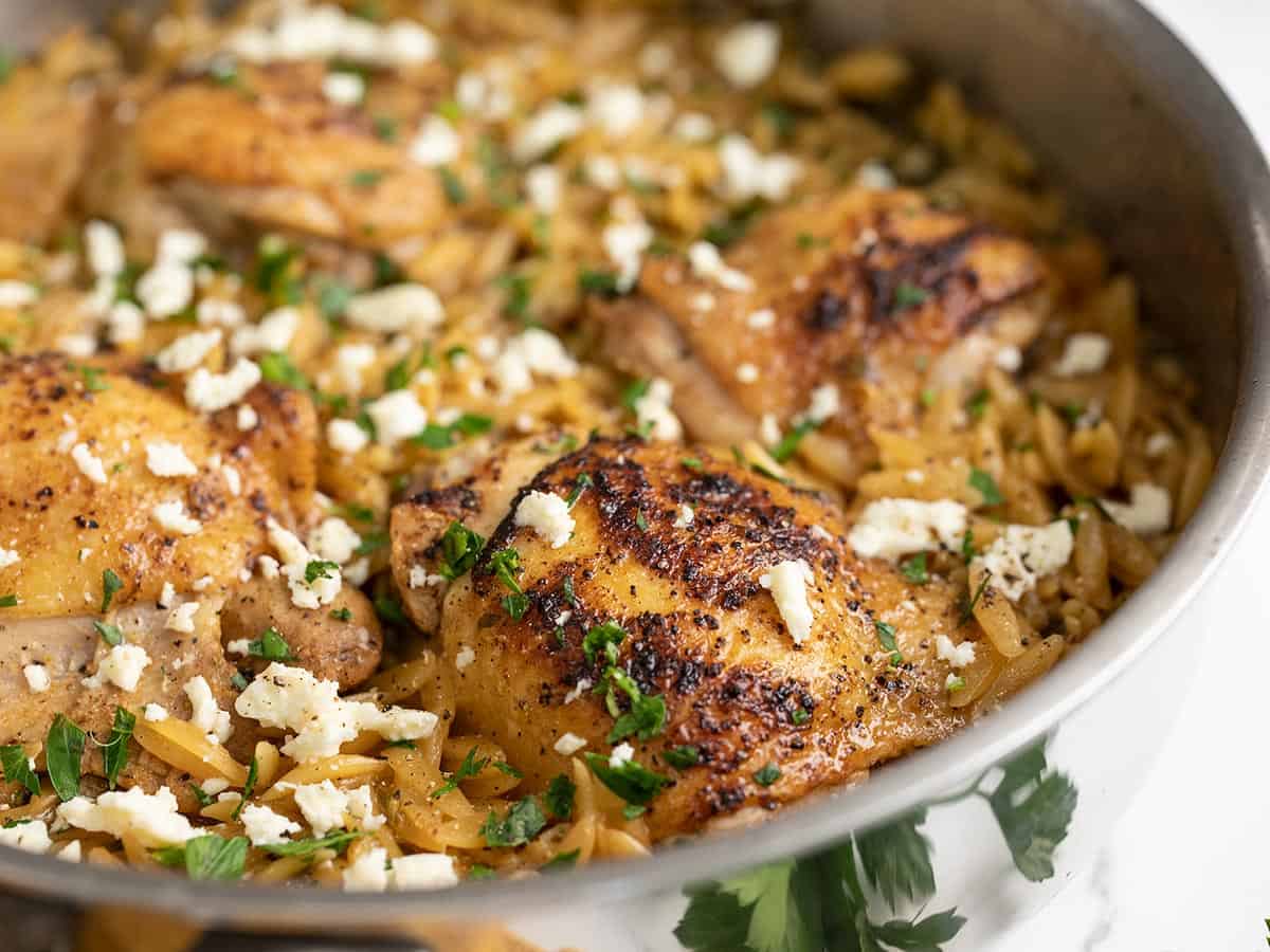 Close up side view of lemon pepper chicken and orzo in the pan.