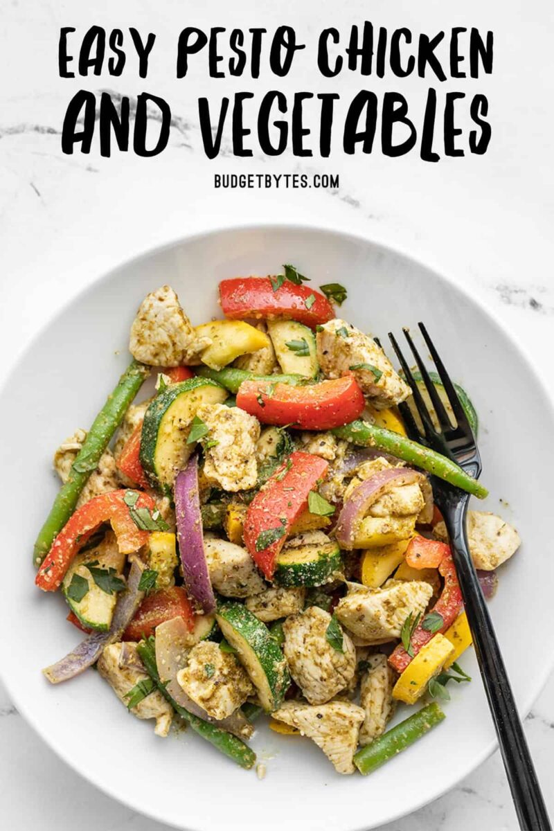 pesto chicken and vegetables in a bowl with a fork, title text at the top