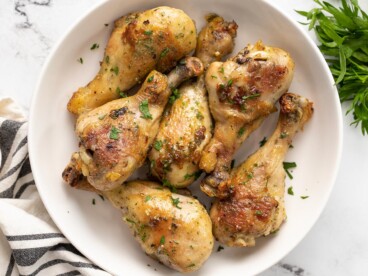 Close up overhead view of ranch chicken drumsticks in a bowl.