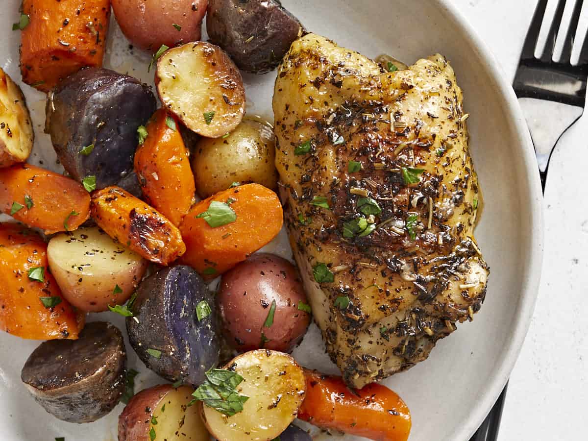 Close up overhead view of chicken and vegetables on the plate. 