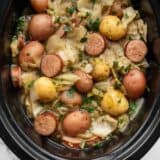 Close up overhead view of cabbage and sausage in the slow cooker