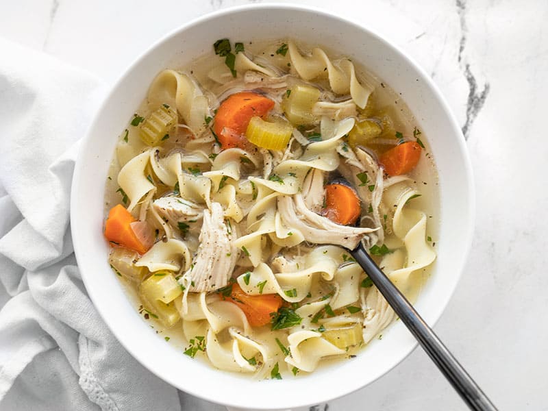 Overhead view of a bowl full of slow cooker chicken noodle soup