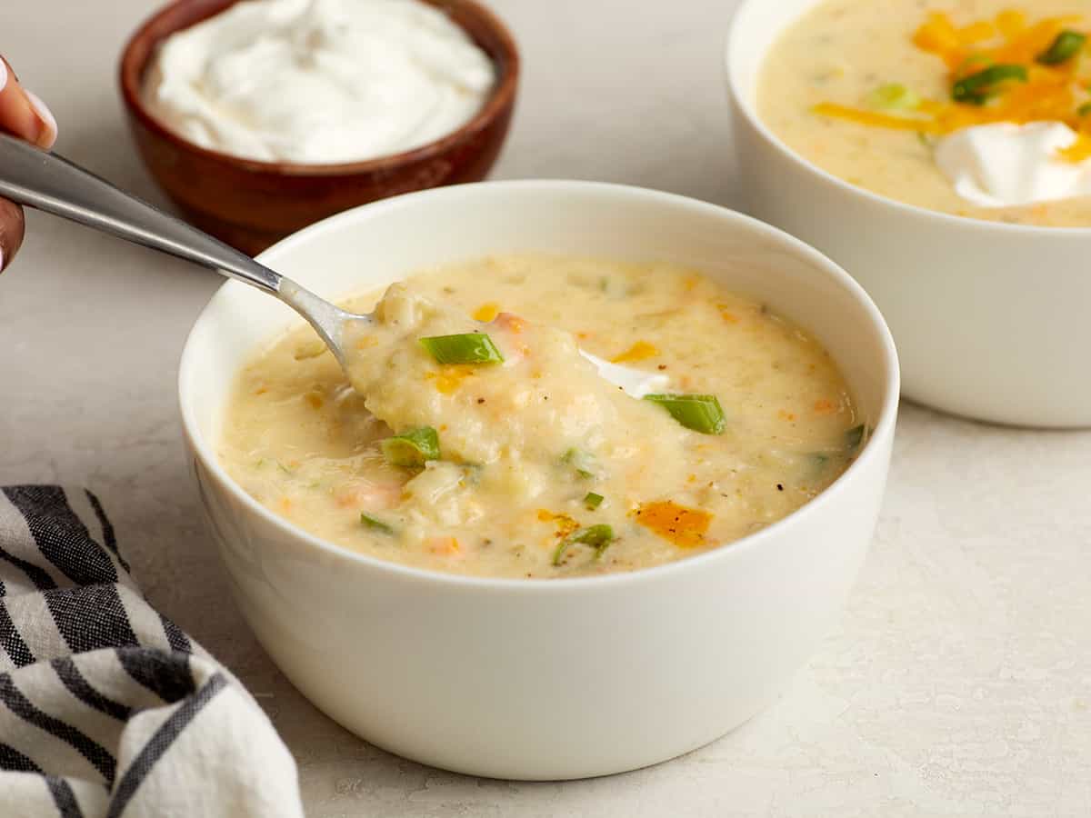 A spoonful of soup being lifted from the bowl.