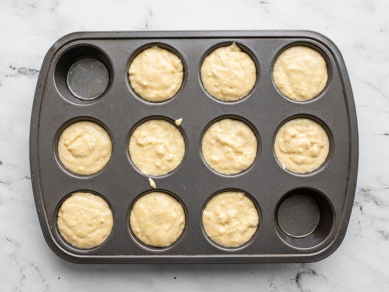 Cornbread batter in a muffin tin