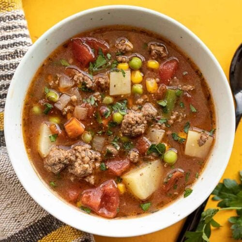 Overhead view of a bowl of vegetable beef soup.